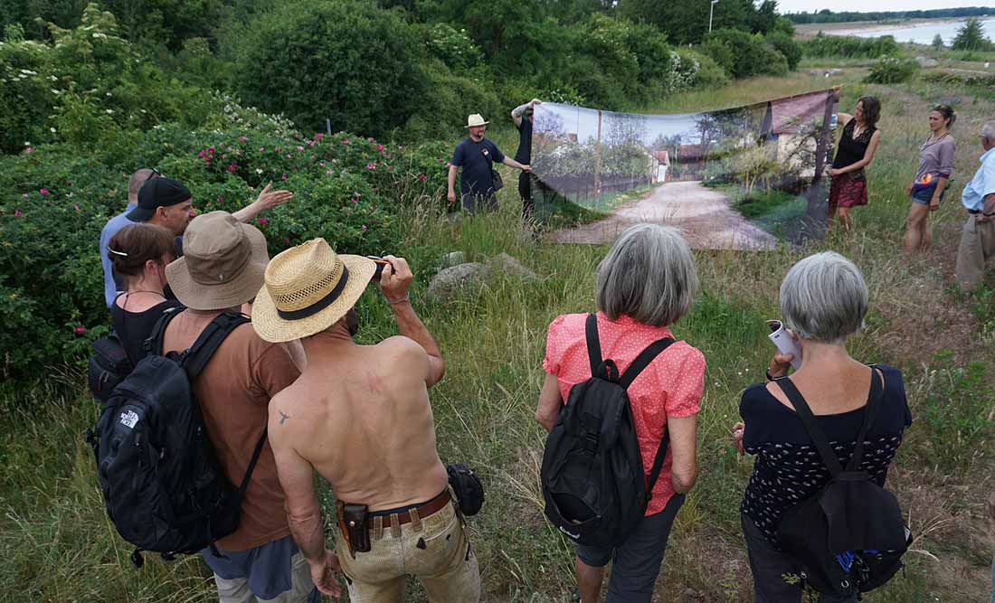 Wanderung auf Höhe der ehemaligen Dorfstraße in Lakoma im Juni 2022. Rene Schuster und Helfer stellen eine alte Dorfansicht der gegenwärtigen Sicht gegenüber